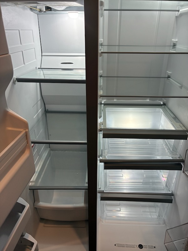 Cleaned, empty refrigerator interior with spotless shelves