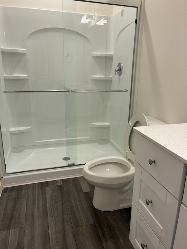 Freshly cleaned bathroom with glass shower and vanity